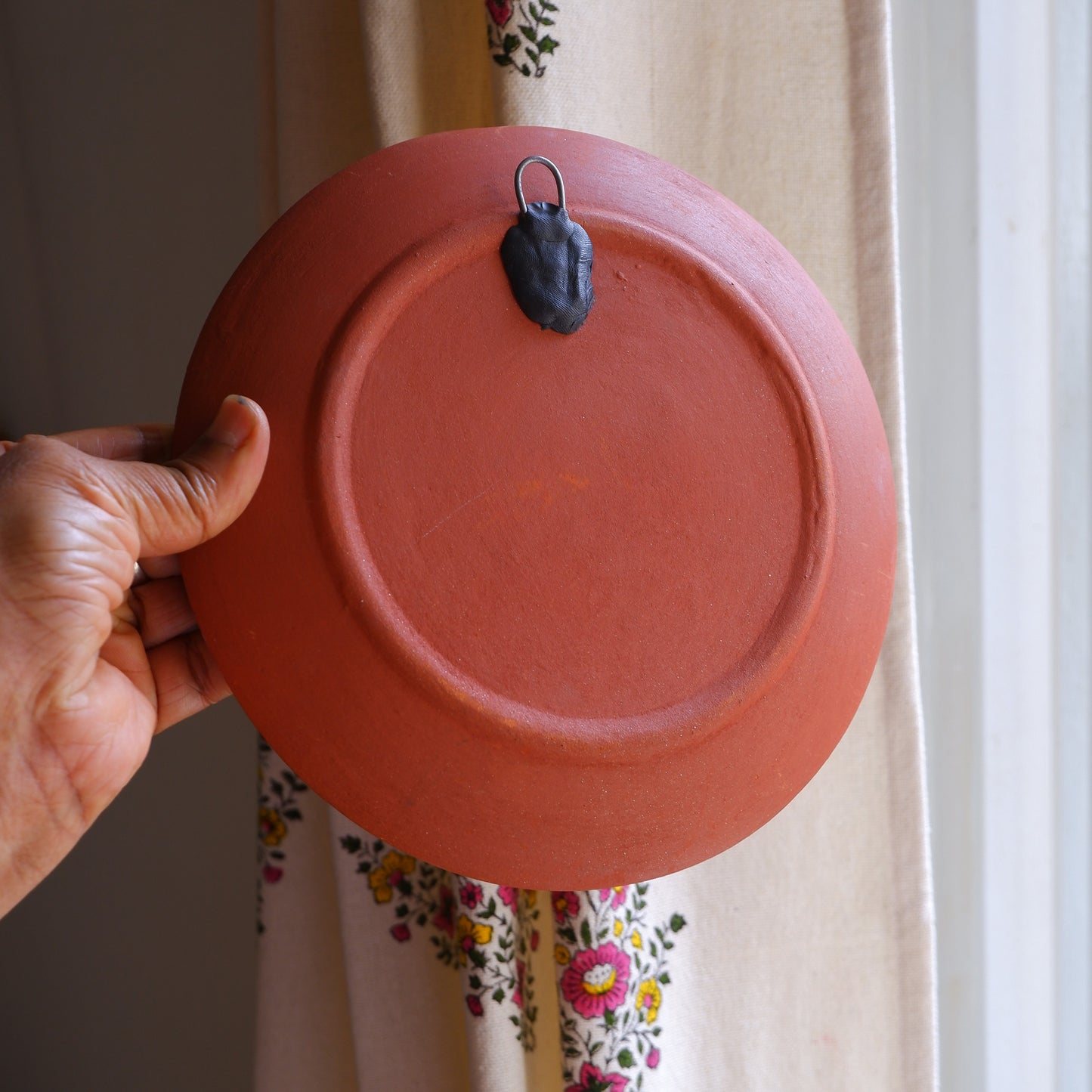 Close-up of 8 inch terracotta wall plate back showing built-in hook for easy hanging