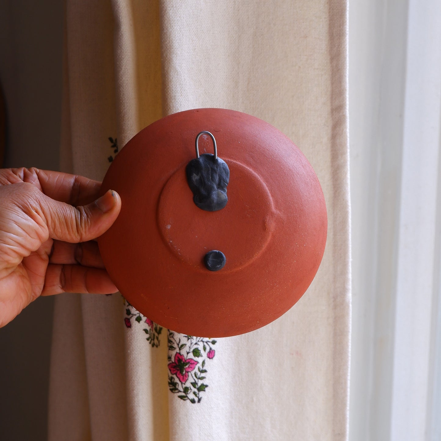 Close-up of 5 inch terracotta wall plate back showing built-in hook for easy hanging