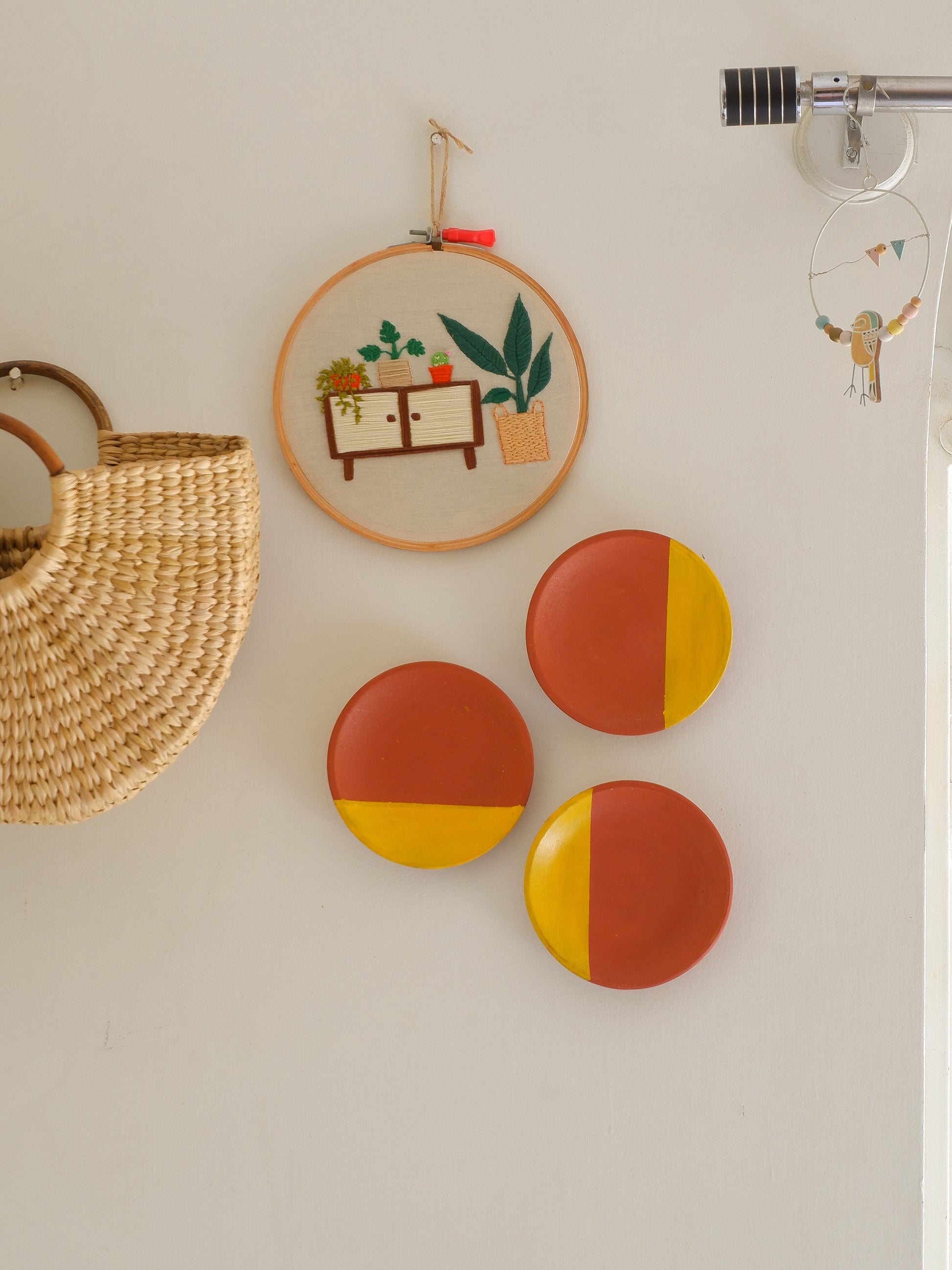 DIY terracotta wall plates arranged on wall, ready to be painted or decorated