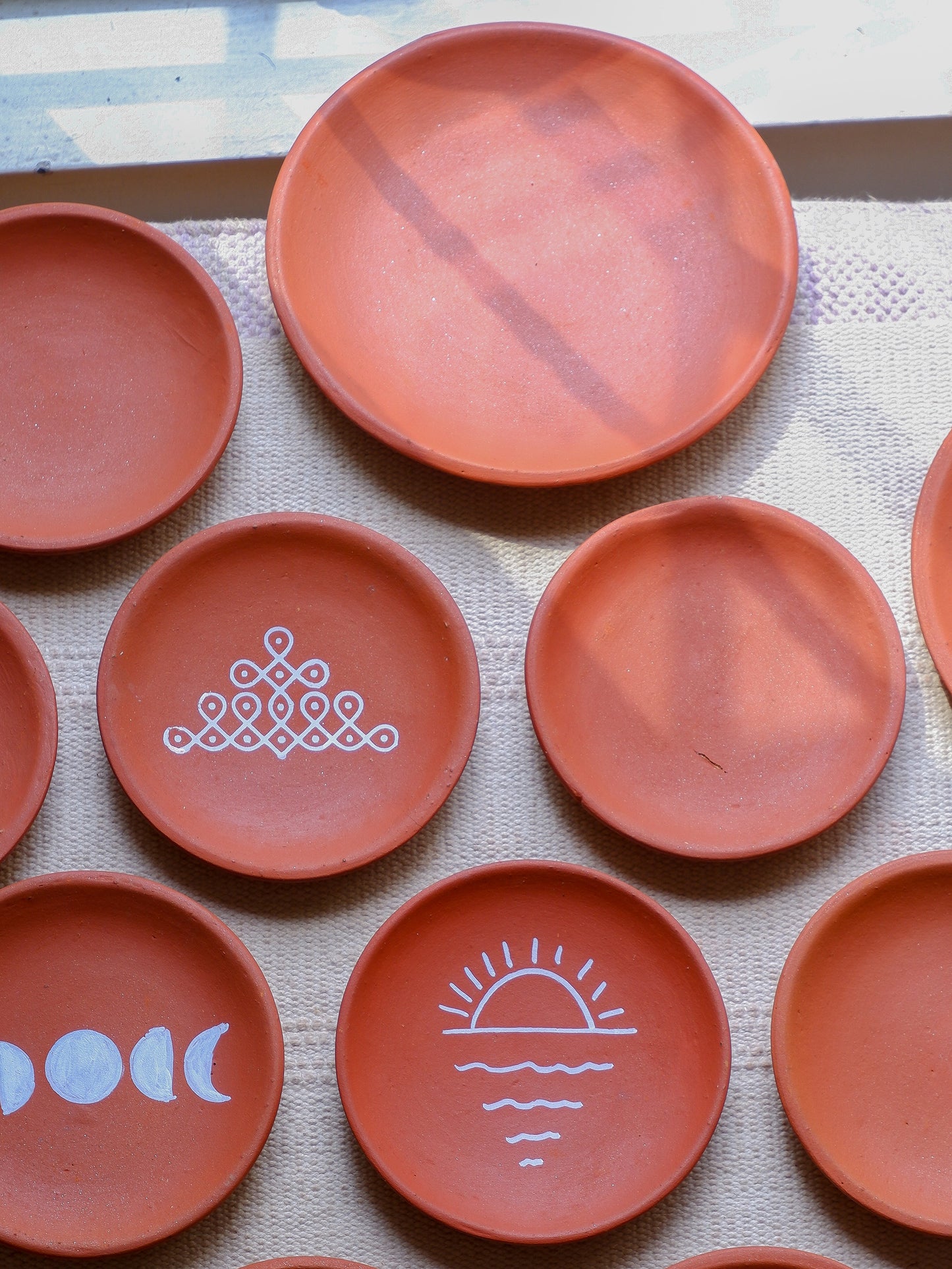 Set of DIY terracotta wall plates in 6 inch and 8 inch sizes in natural clay finish for painting and hanging.”