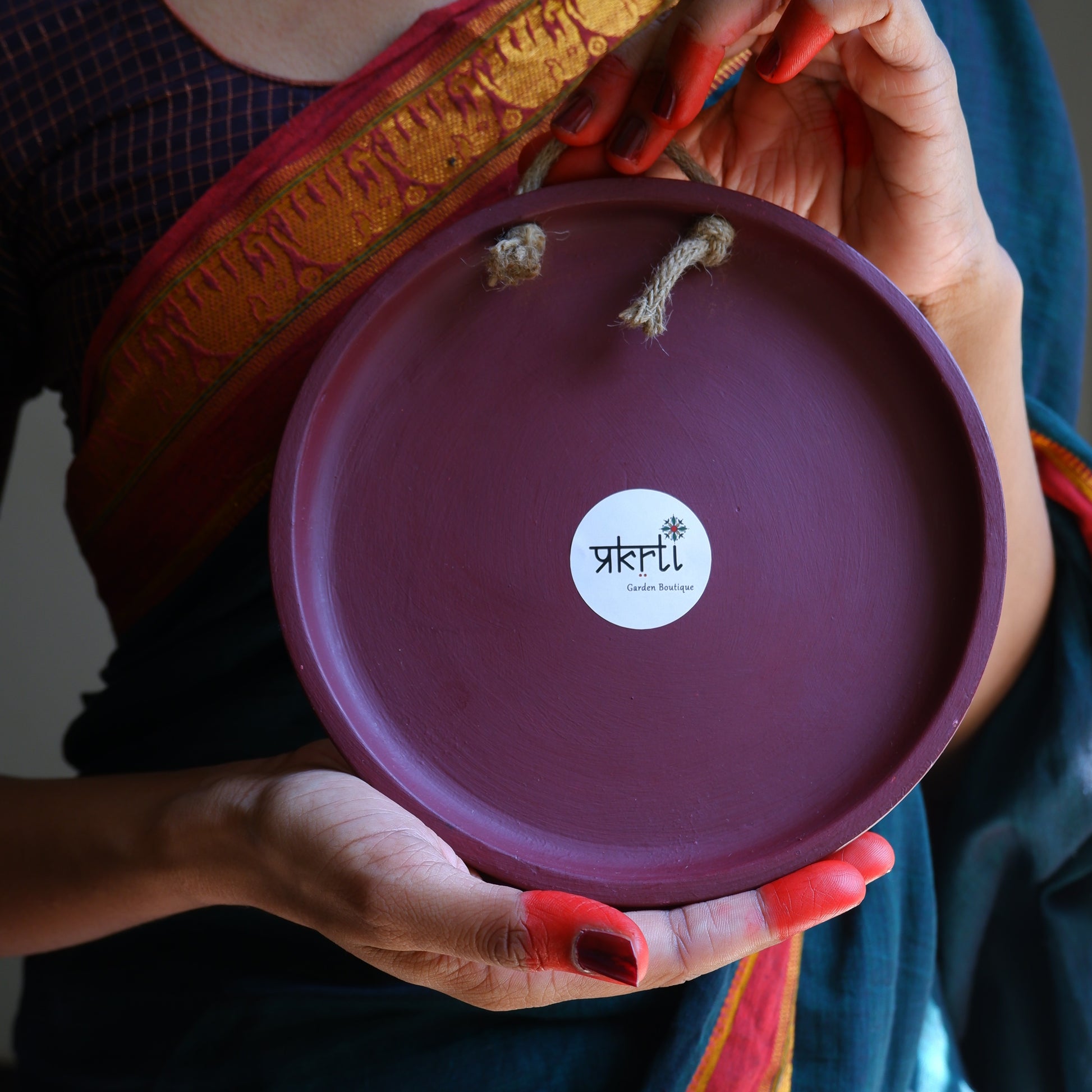 Back view of 8 inch  Maroon Traditional South Indian Sikku Kolam Terracotta Wall Plates for Indian Homes