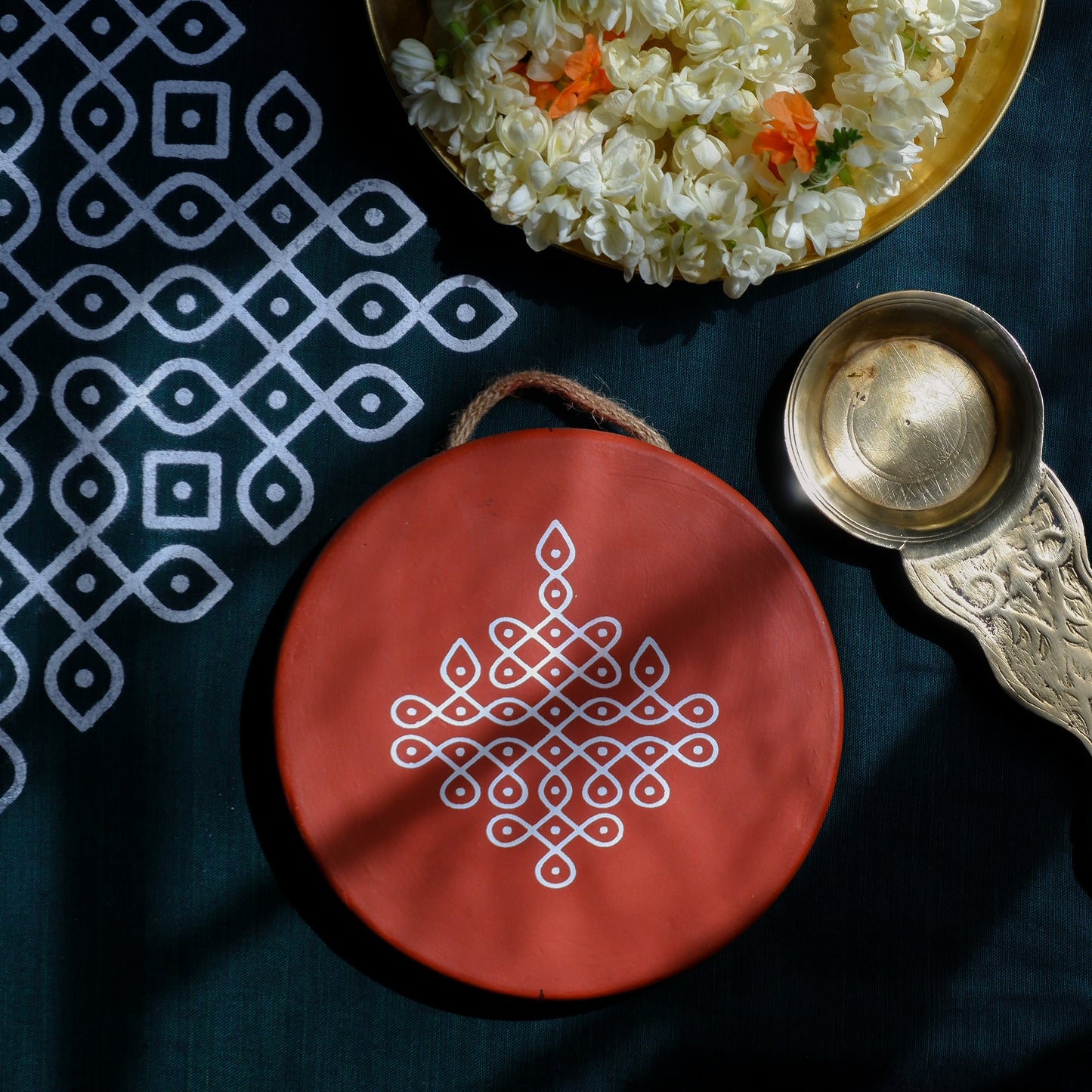 flat lay image of 6 inch Traditional South Indian Sikku Kolam Terracotta Wall Plates for Indian Homes