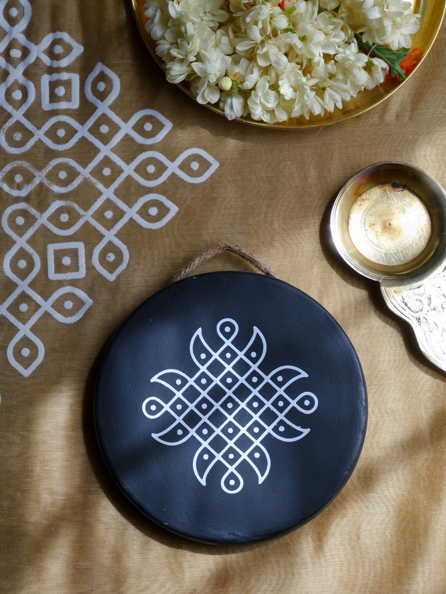 flat lay of our 6 inch black Traditional South Indian Sikku Kolam Terracotta Wall Plates