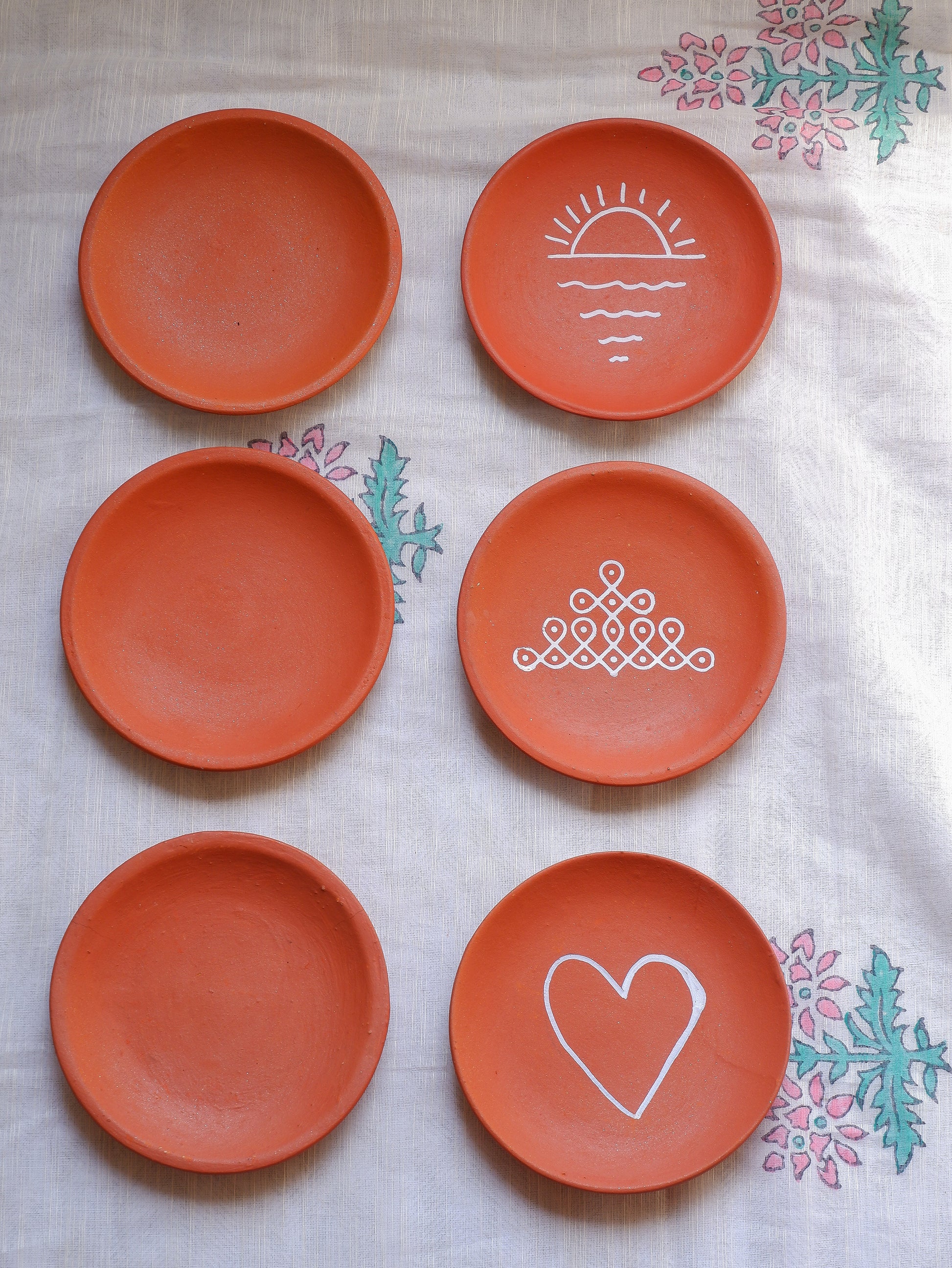 Close-up of blank terracotta wall plate showing smooth clay surface ideal for mandala or dot art.