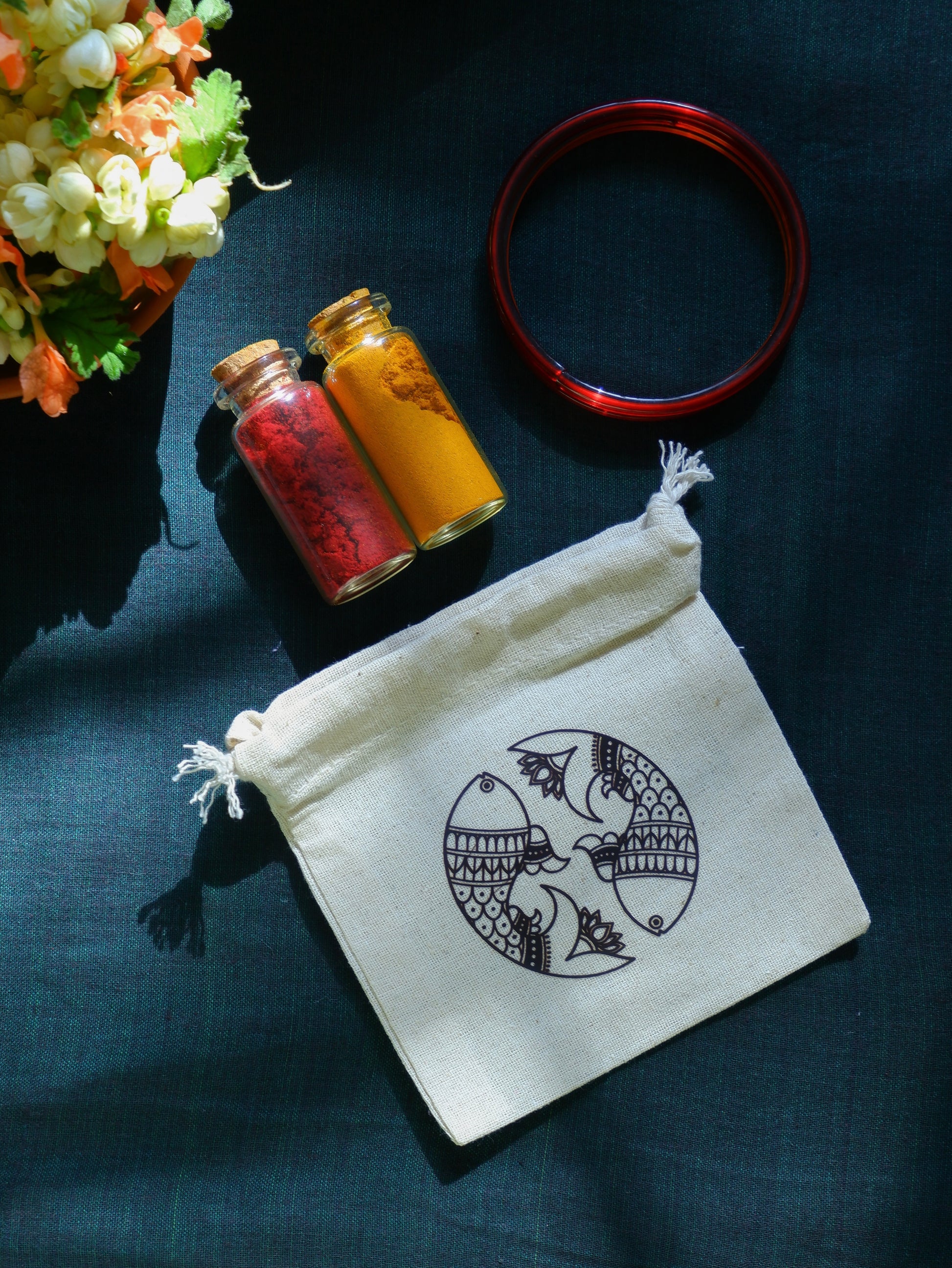 Haldi Kumkum glass bangles in white drawstring bag with Madhubani art return gifting wedding house warming occasions