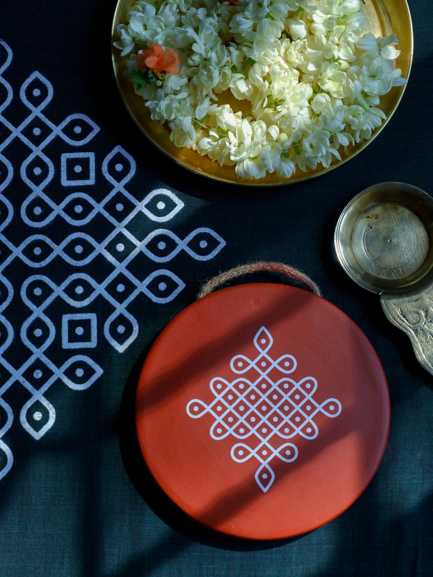 flat lay image of  6 inch Traditional South Indian Sikku Kolam Terracotta Wall Plates for Indian Homes