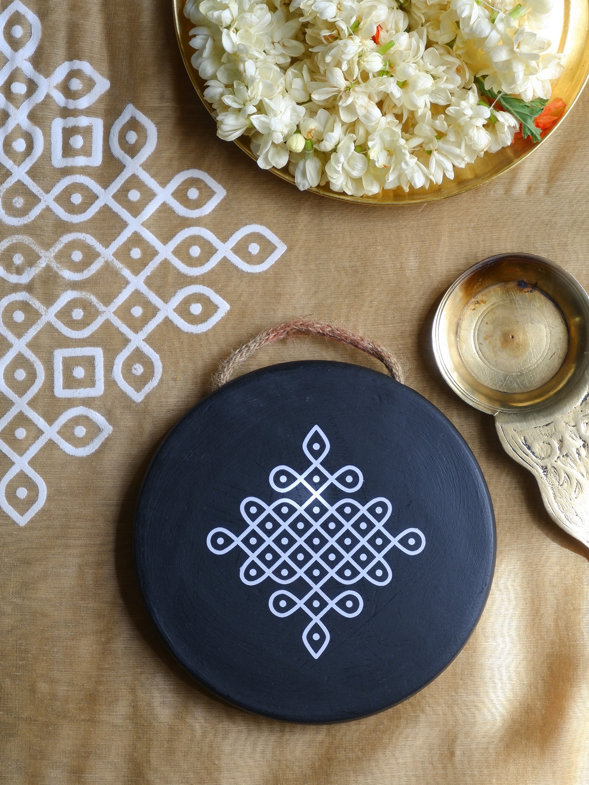 flat lay image of 6 inch black Traditional South Indian Sikku Kolam Terracotta Wall Plates 