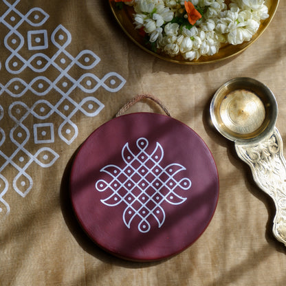 flat lay image of 6 inch  Maroon Traditional South Indian Sikku Kolam Terracotta Wall Plates 