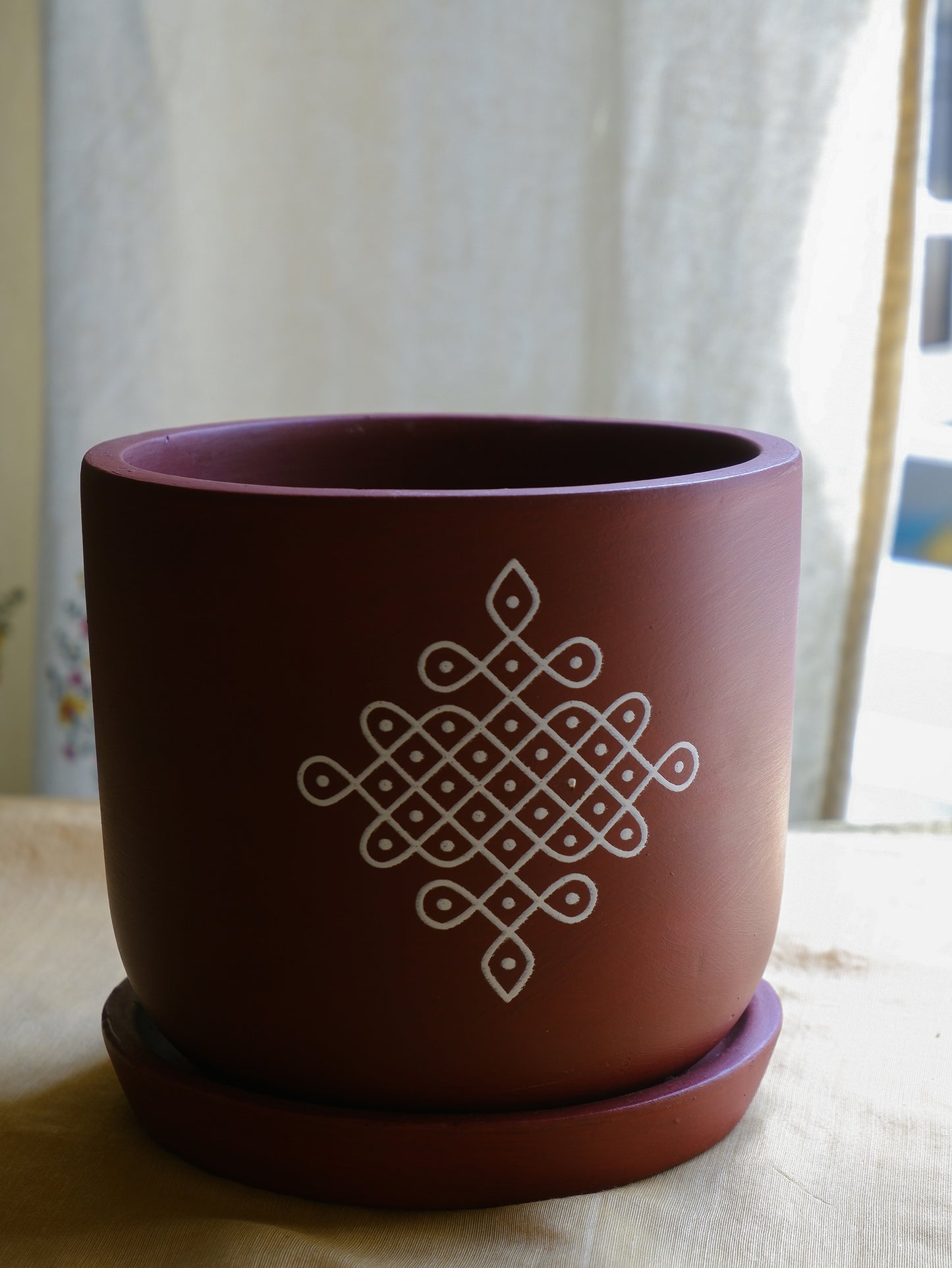 6-inch maroon terracotta planter with white Kolam print