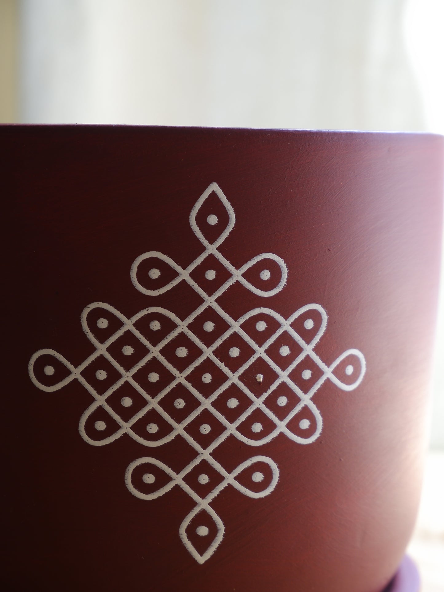 6-inch maroon terracotta planter with white Kolam print