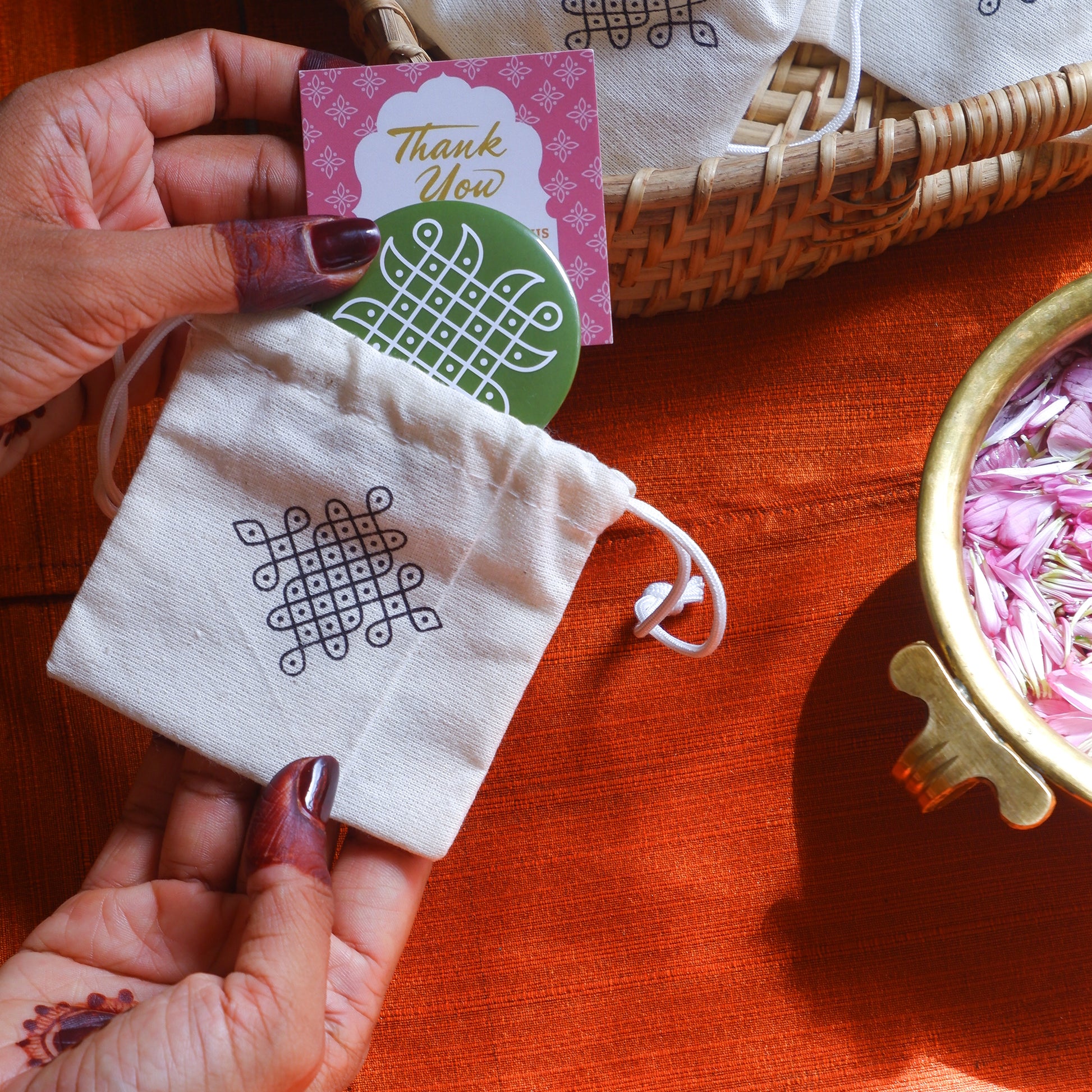 Cotton pouch with a single vibrant round Kolam Fridge Magnet with a Thank You card for return gifting