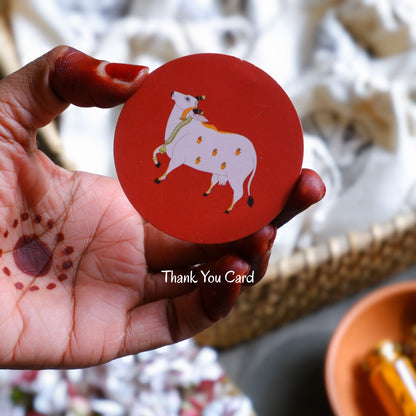 close up of red pichwai cow thank you card housewarming ceremony gifts